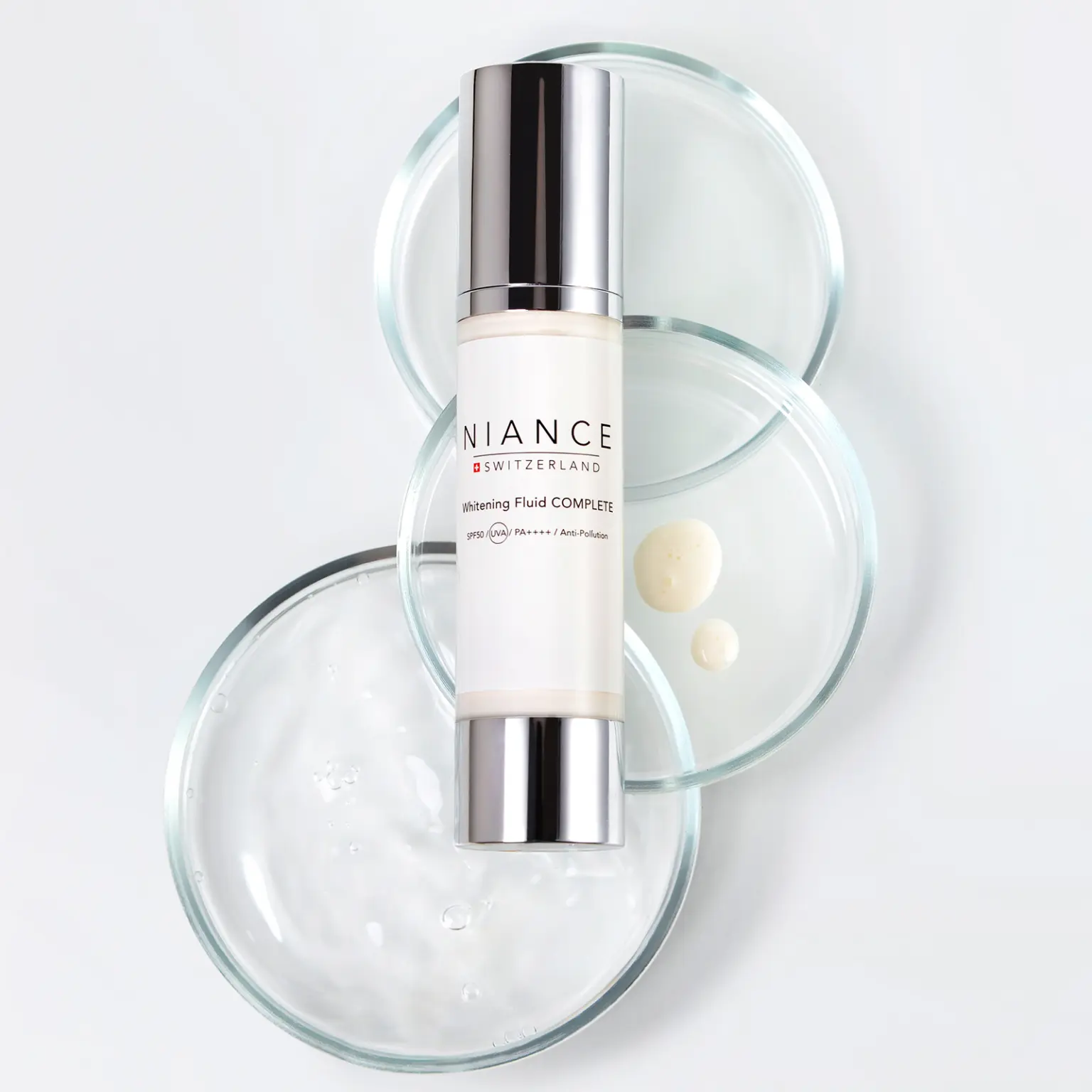 NIANCE Whitening Fluid COMPLETE — light texture swatch for daily protection and brightening