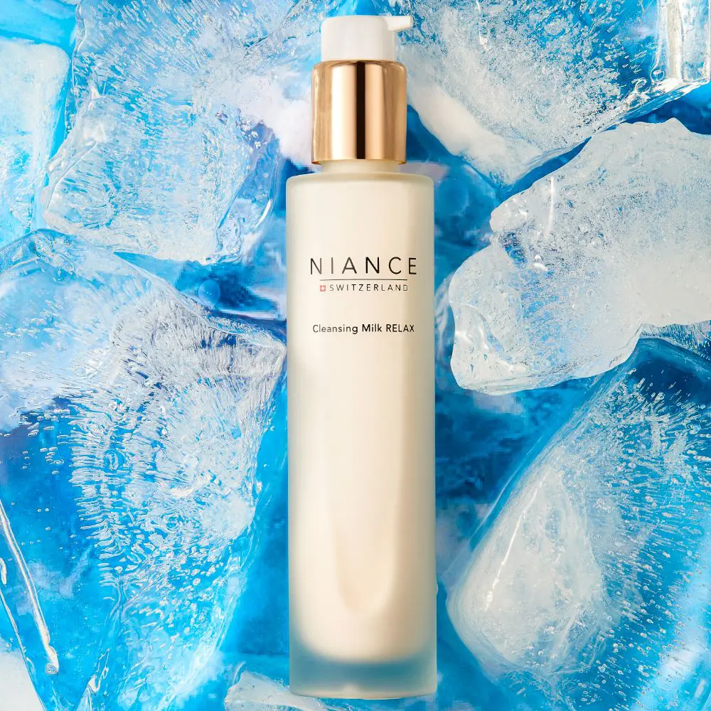 Texture of NIANCE Cleansing Milk RELAX — creamy cleansing milk on hand