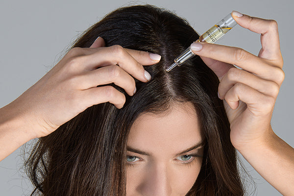 Close-up of Crescina HFSC 1300 Women ampoules and applicator – Swiss precision hair care