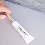 Close-up sculpting balm on fingertip with rich texture